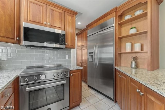 kitchen featuring high end appliances and brown cabinetry