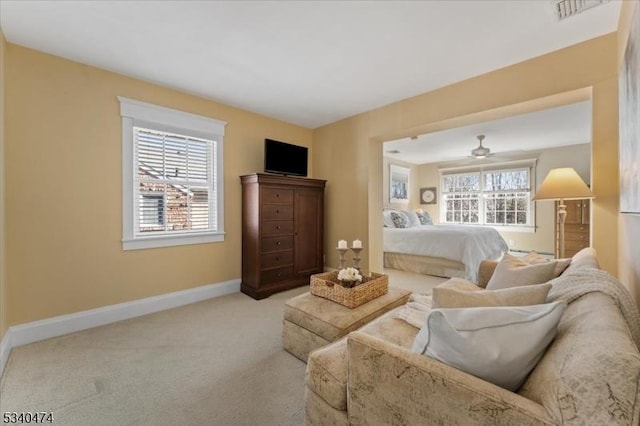 living room with carpet floors, visible vents, and baseboards