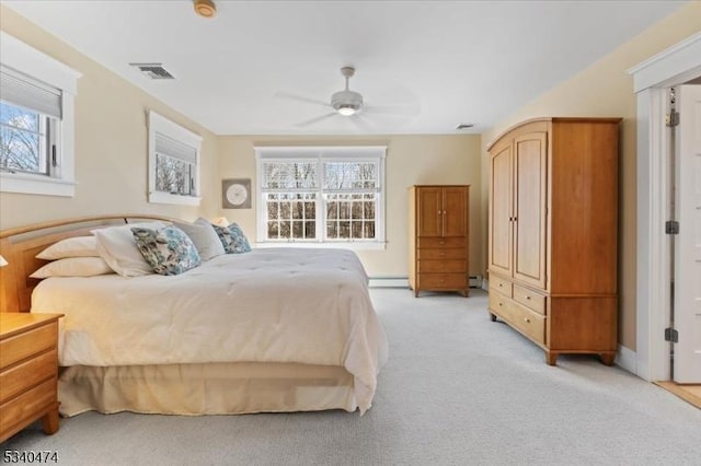 bedroom with a ceiling fan, multiple windows, visible vents, and light colored carpet