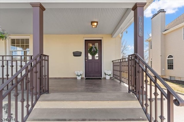 view of exterior entry featuring stucco siding