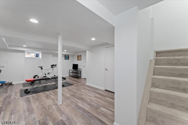 workout area featuring baseboards, wood finished floors, and recessed lighting