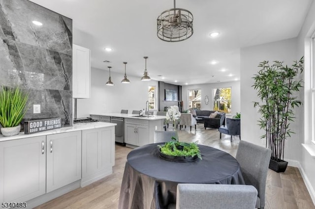 dining space featuring light wood-style flooring and recessed lighting