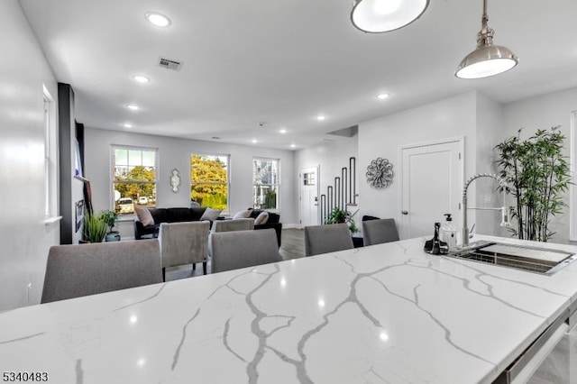 kitchen with recessed lighting, pendant lighting, visible vents, and a sink