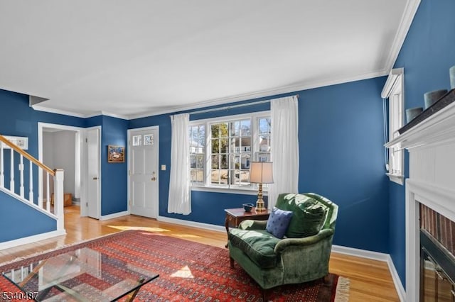 interior space with ornamental molding, stairway, wood finished floors, and baseboards