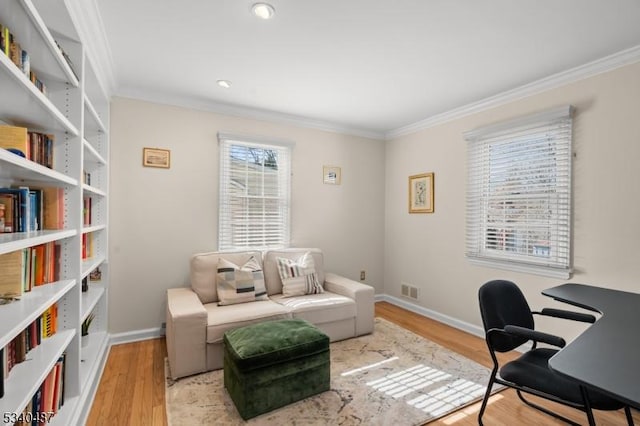 home office featuring ornamental molding, wood finished floors, and visible vents