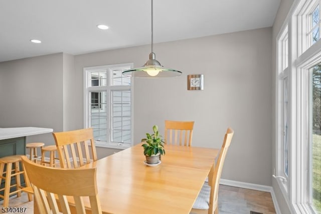 dining space with baseboards, recessed lighting, and a healthy amount of sunlight