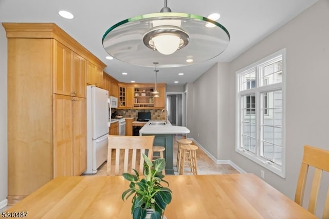 dining room with recessed lighting and baseboards