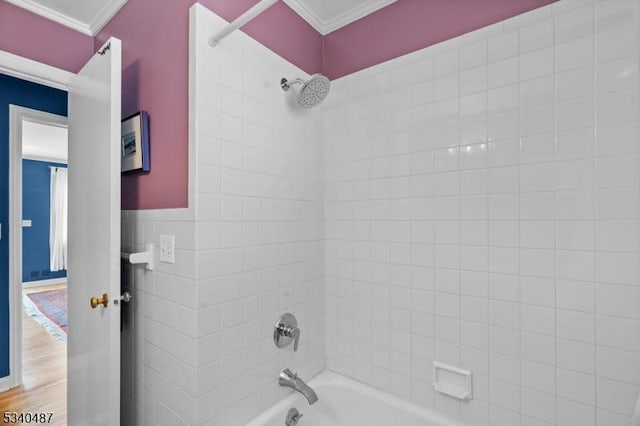 bathroom with tub / shower combination, crown molding, and wood finished floors