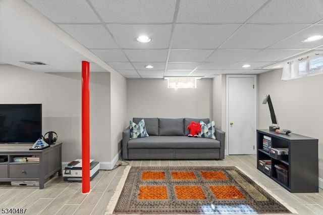 living room with baseboards, visible vents, a drop ceiling, wood tiled floor, and recessed lighting