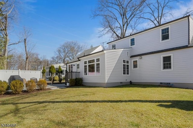 back of house with a yard and fence