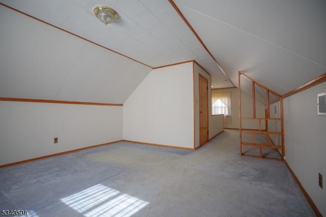 additional living space featuring lofted ceiling and carpet floors