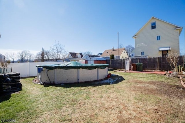 view of yard with a fenced in pool and a fenced backyard