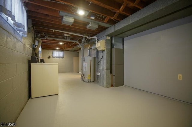 basement with water heater, washer / dryer, and heating unit