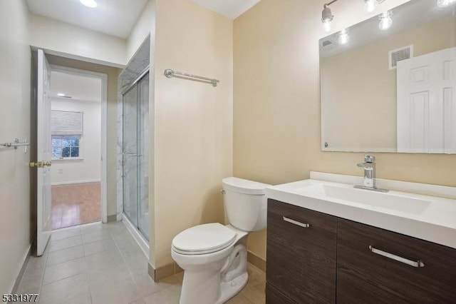 bathroom featuring toilet, tile patterned flooring, visible vents, and a shower stall