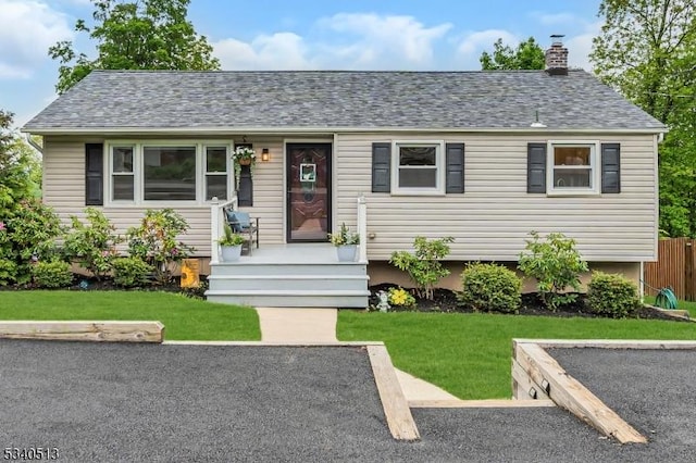 637 Bensel Dr, Mount Arlington Boro, NJ 07850 - view of front facade featuring a chimney, a front lawn, and a shingled roof