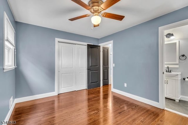 637 Bensel Dr, Mount Arlington Boro, NJ 07850 - unfurnished bedroom with baseboards, a closet, wood finished floors, ensuite bathroom, and a ceiling fan