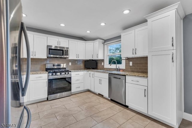 637 Bensel Dr, Mount Arlington Boro, NJ 07850 - kitchen featuring stainless steel appliances, a sink, tasteful backsplash, white cabinets, and recessed lighting