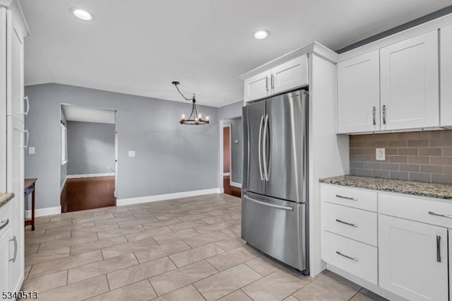 637 Bensel Dr, Mount Arlington Boro, NJ 07850 - kitchen with freestanding refrigerator, a chandelier, white cabinets, light stone countertops, and recessed lighting