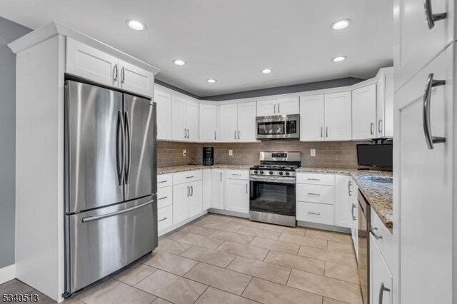 637 Bensel Dr, Mount Arlington Boro, NJ 07850 - kitchen with appliances with stainless steel finishes, backsplash, recessed lighting, white cabinets, and light stone counters