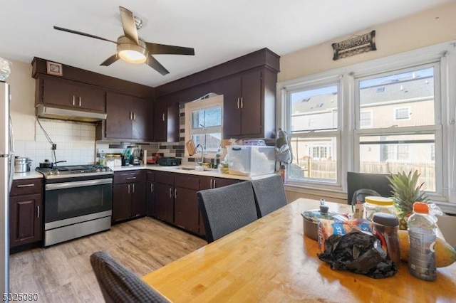 kitchen featuring a healthy amount of sunlight, light countertops, a sink, and gas stove