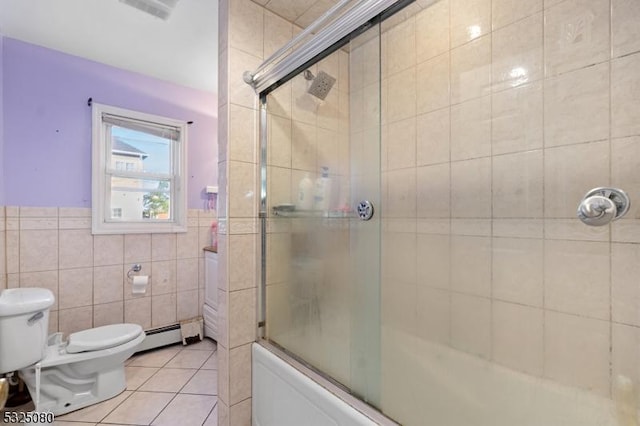 bathroom with tile walls, toilet, wainscoting, combined bath / shower with glass door, and tile patterned flooring