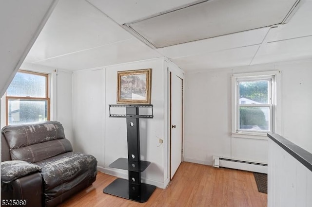 sitting room with a baseboard radiator and light wood-style flooring