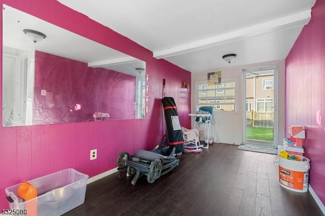 rec room with baseboards, dark wood finished floors, and beam ceiling