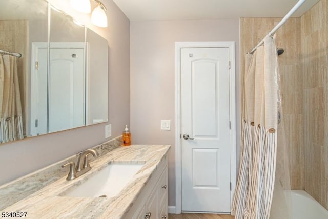 bathroom featuring vanity and shower / bathtub combination with curtain