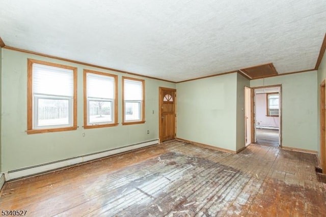 empty room featuring a baseboard radiator, wood-type flooring, baseboards, and crown molding