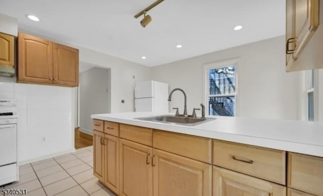 kitchen with light tile patterned flooring, recessed lighting, white appliances, a sink, and light countertops