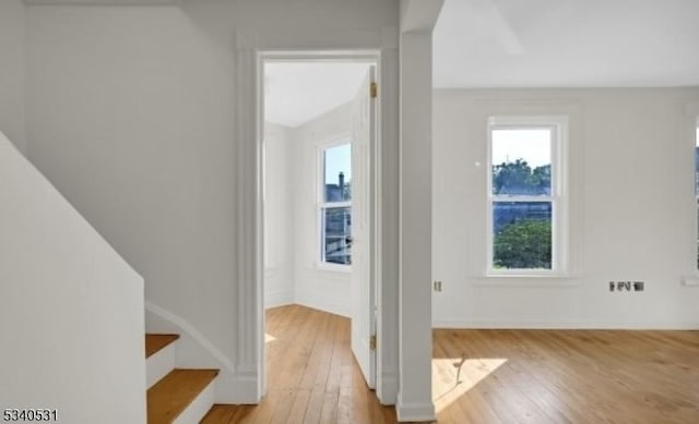 interior space with stairway, baseboards, and hardwood / wood-style flooring