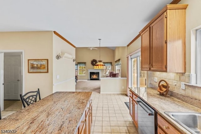 kitchen with lofted ceiling, backsplash, light tile patterned flooring, dishwasher, and a lit fireplace