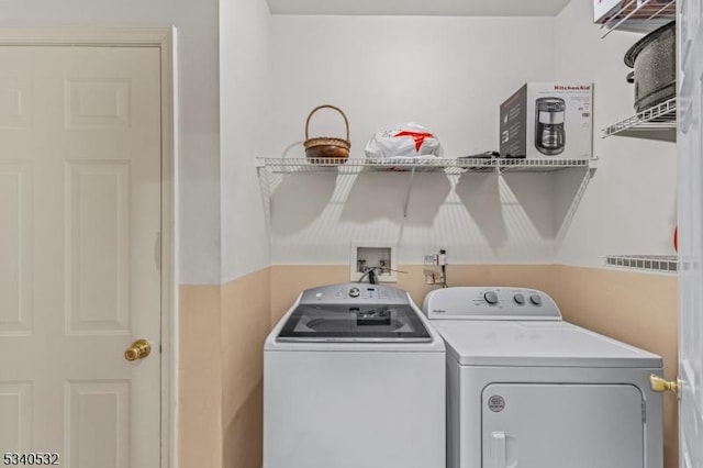 clothes washing area featuring laundry area and washing machine and clothes dryer