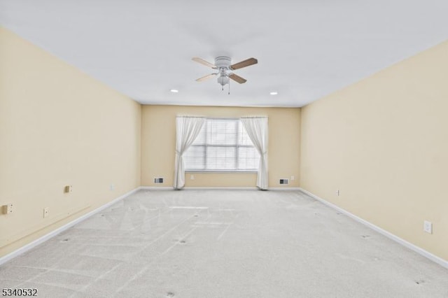 carpeted spare room featuring ceiling fan, visible vents, baseboards, and recessed lighting