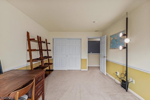 home office with carpet floors and baseboards