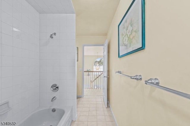 bathroom featuring tub / shower combination, tile patterned flooring, and baseboards