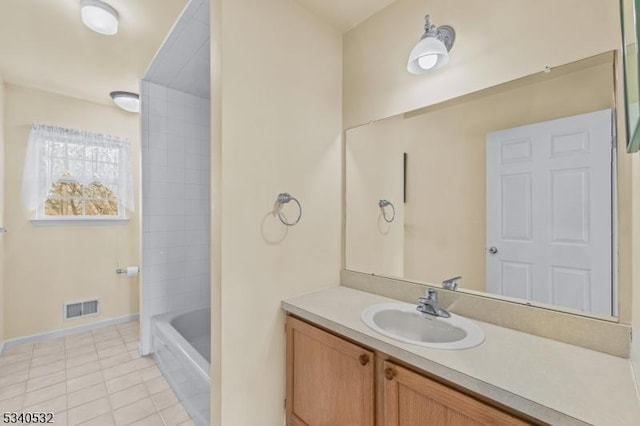 bathroom with visible vents, vanity, baseboards, and tile patterned floors