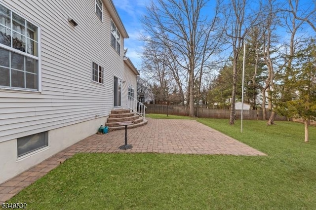 view of yard featuring entry steps, a patio area, and fence