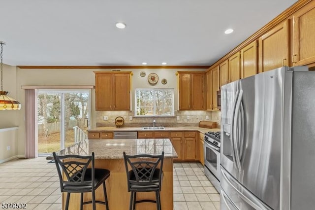 kitchen featuring light tile patterned floors, appliances with stainless steel finishes, a sink, and tasteful backsplash