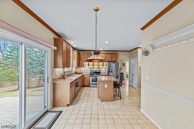 kitchen with decorative backsplash, ornamental molding, a breakfast bar, stainless steel appliances, and a sink