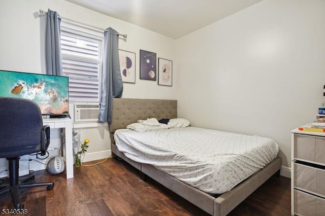 bedroom featuring cooling unit, baseboards, and dark wood-type flooring