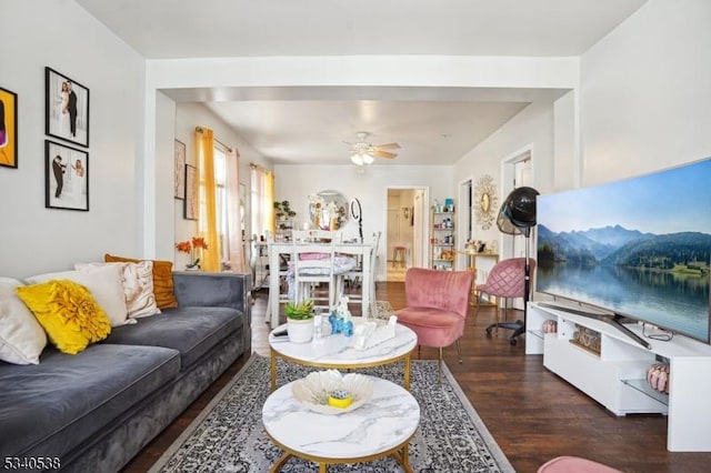 living area with ceiling fan and wood finished floors