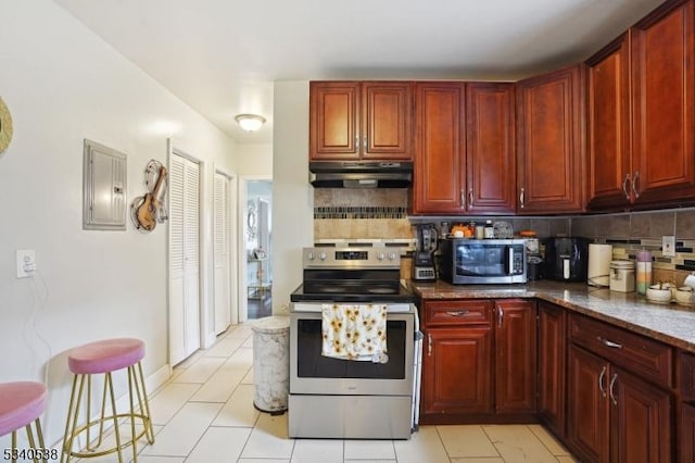 kitchen with stainless steel appliances, decorative backsplash, dark stone counters, electric panel, and under cabinet range hood