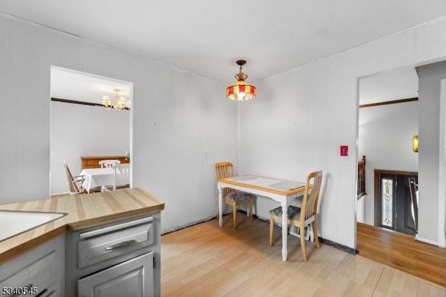 dining area with a chandelier and light wood-style floors