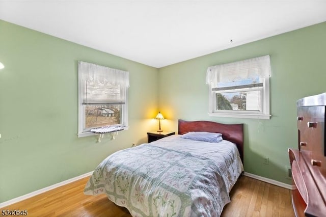 bedroom featuring baseboards and wood finished floors