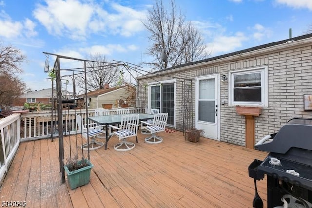 wooden deck featuring outdoor dining area and area for grilling