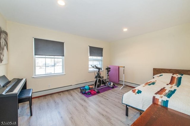 bedroom featuring a baseboard radiator, wood finished floors, and recessed lighting