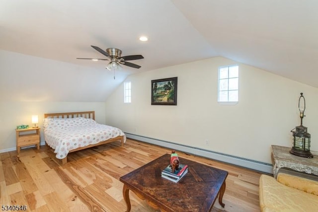 bedroom with lofted ceiling, ceiling fan, a baseboard radiator, and wood finished floors