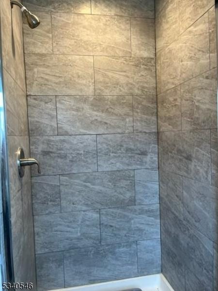 bathroom with a tile shower