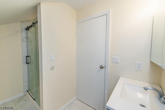 full bath with marble finish floor, a stall shower, vanity, and baseboards